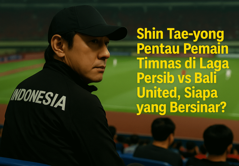 Shin Tae-yong duduk di tribun stadion sambil memantau pertandingan Persib vs Bali United dengan serius, mengenakan jaket bertuliskan INDONESIA